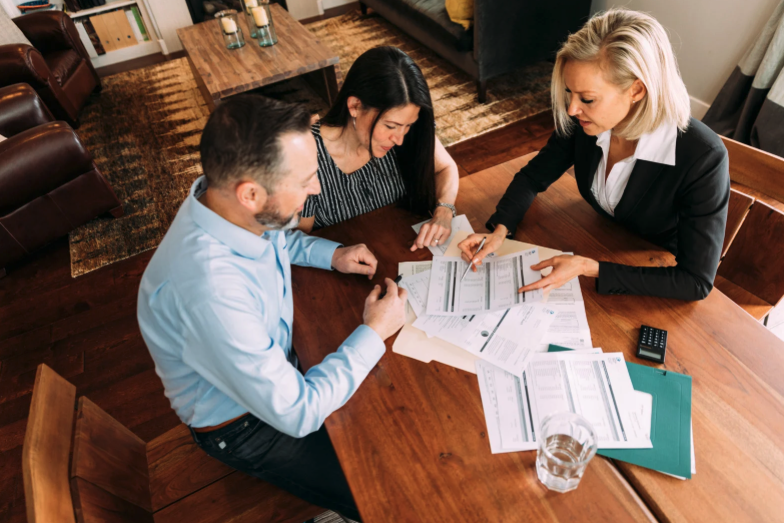 A business advisor meeting with clients at a conference room table.